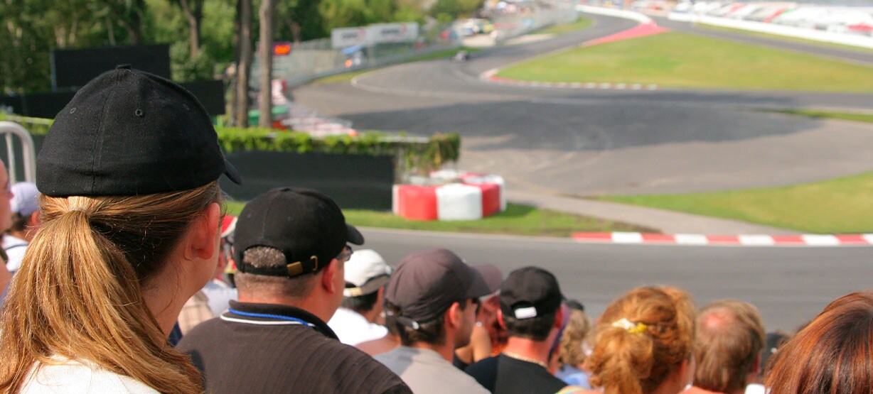 spectators in the grandstand, racetrack in the background