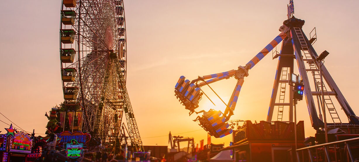 Ferris wheel and amusement park attraction at sunset