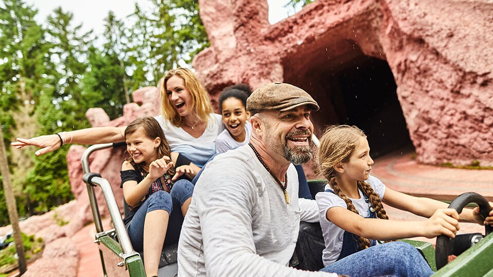 family on a children's amusement park ride